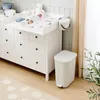 A nursery or changing room setting with a white dresser and changing station. Produktbild-Vorschau