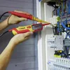 A person is using two Wiha voltage testers to check electrical wiring in a distribution box. Náhľad obrázku produktu