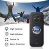 A black action camera is shown in the foreground, with a scenic mountain landscape featuring people jumping in the background. Náhled obrázku produktu