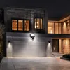 A modern house at night with a lit garage and entrance. Produktbild-Vorschau