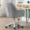 A gray office chair with a white base and wheels is shown from the back, next to a white desk with wooden drawers. Náhľad obrázku produktu