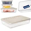 A collection of clear plastic food storage containers with beige lids, some filled with food items like blueberries, cheese, and ham, and one container with a branded tag. Produktbild-Vorschau
