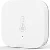A white smart home sensor with a thermometer icon on its surface. Voir les images du produit
