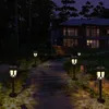 A pathway lined with solar garden lights leads to a modern house at dusk. Produktbild-Vorschau