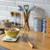 Kitchen counter with various cooking utensils and ingredients. Anteprima dell’immagine prodotto