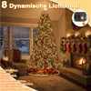 A decorated Christmas tree with lights and gifts in a cozy room with a fireplace. Anteprima dell’immagine prodotto