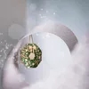 A Christmas wreath is displayed, surrounded by a shimmering silver ribbon and sparkling lights. Produktbild-Vorschau