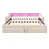 A beige upholstered daybed with a slatted mattress base is shown from the front, with pink LED lighting illuminating the headboard. Produktbild-Vorschau