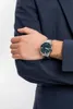 A person wearing a dark blue suit and a watch. Podgląd zdjęcia produktu