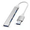 A silver USB hub with four blue USB ports and a white cable connected to a silver USB connector. Produktbild-Vorschau