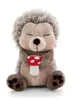 A plush hedgehog toy sitting and holding a mushroom. Produktbild-Vorschau