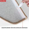 A close-up view of the underside of a carpet stair tread, showing the self-adhesive backing being peeled off by a hand. Produktbild-Vorschau