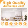 A modern living room with a ceiling light, sofa, and dining area. Voir les images du produit
