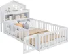 A white wooden children's bed with a house-shaped headboard and integrated shelving, featuring protective rails and a small gate. Anteprima dell’immagine prodotto