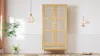 A wooden wardrobe with rattan-like doors and a drawer in a brightly lit room. Produktbild-Vorschau