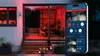 A modern house exterior at night with red lighting, featuring a sliding glass door and a smartphone displaying a security camera app. Anteprima dell’immagine prodotto