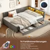 A daybed with storage drawers and LED lighting, styled with pillows and blankets. Produktbild-Vorschau