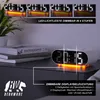 A digital alarm clock with orange LED lighting is displayed on a nightstand next to books. Anteprima dell’immagine prodotto