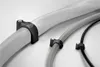 Three cable clips are shown attached to different cables against a plain background. Anteprima dell’immagine prodotto