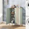 A light green cabinet with gold accents is shown in a bathroom setting, next to a bathtub and washing machines. Produktbild-Vorschau