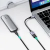 A Ugreen USB-C to USB-A adapter cable connecting a portable storage device to a laptop. Podgląd zdjęcia produktu