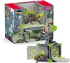 A toy playset featuring a chameleon creature and its battle cave, presented in its retail packaging. Produktbild-Vorschau