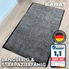 A gray ribbed doormat is shown on a wooden floor. Náhled obrázku produktu