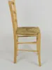Side view of a wooden chair with a straw seat. Produktbild-Vorschau