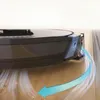 A robotic vacuum cleaner is shown cleaning a floor, with a blue arrow indicating its movement and airflow. Produktbild-Vorschau