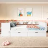 A white bed with drawers and shelves in a child's room, decorated with colorful artwork. Produktbild-Vorschau