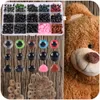 A close-up view of a craft safety eyes and noses set, along with a portion of a teddy bear. Náhled obrázku produktu