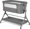 A gray baby crib with a mesh window and a storage tray underneath, shown on a white background. Produktbild-Vorschau