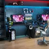 A gaming desk setup with multiple monitors, keyboards, headphones, and a computer tower, illuminated by blue and red LED lights. Voir les images du produit