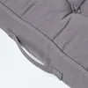 A close-up view of a gray cushion with a handle. Náhled obrázku produktu