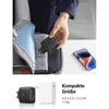 A person is placing a black USB charger into a bag, with a smartphone and another charger visible on a table. Produktbild-Vorschau