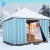 A gazebo covered in snow, with blue curtains drawn around it, showing heat rising inside. Voir les images du produit