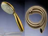 A collage showing a gold hand shower head and a coiled gold shower hose against a gradient background. Produktbild-Vorschau