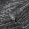 A roll of wallpaper with a stone pattern is shown in close-up. Náhľad obrázku produktu