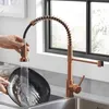 A person is washing a pan under a copper kitchen faucet. Anteprima dell’immagine prodotto