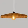 A pendant lamp with a woven jute shade and a visible light bulb, set against a plain background. Podgląd zdjęcia produktu