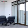 A balcony or patio area with modern outdoor furniture and large glass doors. Anteprima dell’immagine prodotto