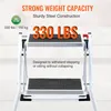 A close-up view of a white two-step ladder with black anti-slip treads, highlighting its weight capacity and sturdy construction. Voir les images du produit
