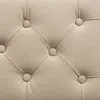 A close-up view of tufted beige upholstery with buttons. Podgląd zdjęcia produktu