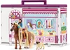 A toy playset depicting a pet grooming salon with figures of a girl, a horse, a cat, and a pug. Produktbild-Vorschau