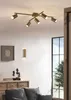 A modern living room with a ceiling light fixture and wall sconces. Produktbild-Vorschau