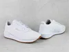 Two white Puma sneakers are displayed on a light gray concrete surface. Produktbild-Vorschau