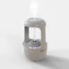 A white humidifier with a light blue LED ring on top, emitting mist and water droplets. Náhled obrázku produktu