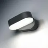 A modern, dark gray outdoor wall light with a white diffuser is mounted on a textured gray wall. Produktbild-Vorschau