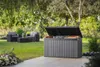 A garden storage box is open and filled with cushions on a patio, with garden furniture and greenery in the background. Voir les images du produit