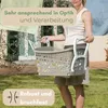 A woman is holding a laundry basket in a garden setting. Produktbild-Vorschau